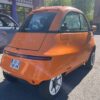 Microlino Orange Amesterdam trois quart arrière gauche